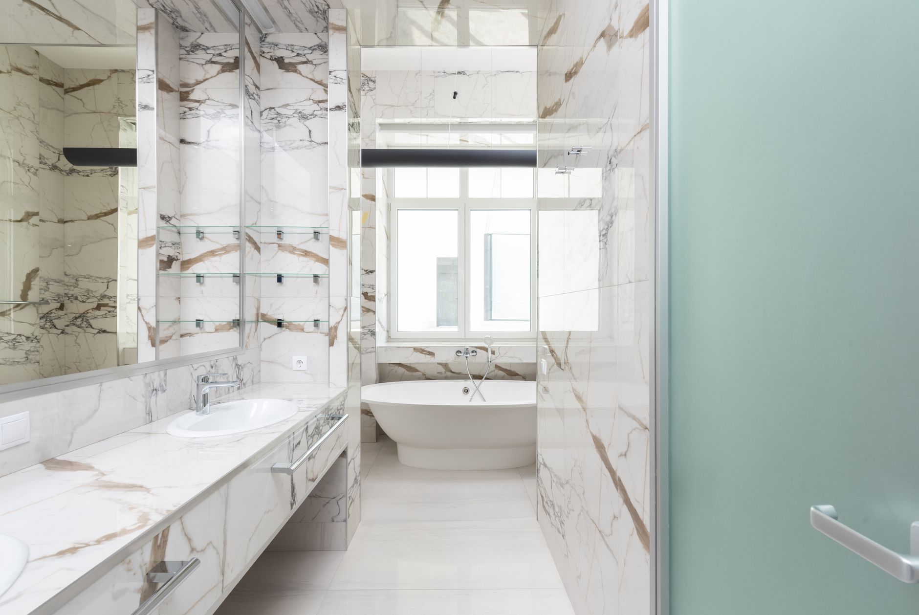A stylish bathroom featuring a marble design and contemporary bathtub, ideal for luxury interiors in Riverside, CA